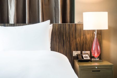 White Pillow on bed with table light lamp decoration in bedroom interior